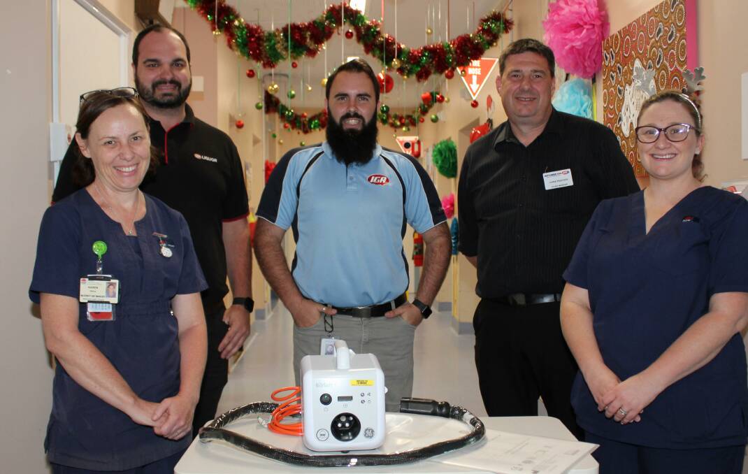 CHRISTMAS PHOTO THERAPY: Maternity Unit Manager Karen Atkins and midwife Mel Tait (right) with Dean Brown of Bowraville IGA, IGA Regional Manager Josh Gilmour and Ritchies Nambucca manager Chris Peacock.

 