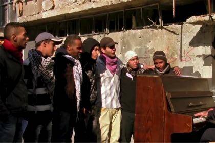 In this still from the film "Blue", Ayham al-Ahmad leads Palestinian youth in song in Yarmouk. Photo: Supplied