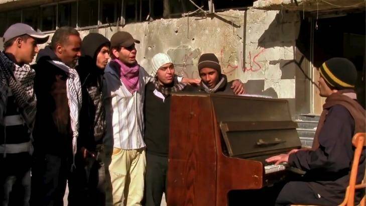 In this still from the film "Blue", Ayham al-Ahmad leads Palestinian youth in song in Yarmouk. Photo: Supplied