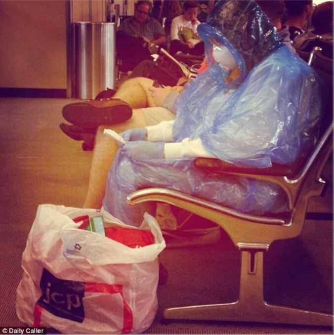 A woman wears a Hazmat suit at a US airport: it's unclear whether it was a stunt. Photo: The Daily Caller