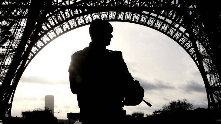 Armed military patrol the Eiffel Tower. Photo: Andrew Meares