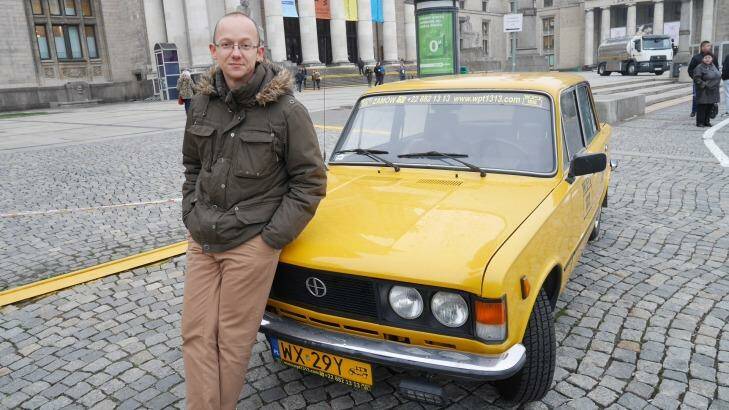 Afraid of Russia: Warsaw tour guide Marek Sidorenko with the old car that he uses for the tours. Photo: Nick Miller