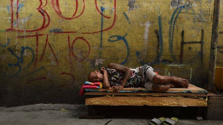 A man sleeps on a makeshift bed in one of the alleys in Tondo district in Manila, Philippines.  Photo: Kate Geraghty