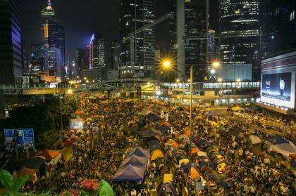 Enthralled: Tens of thousands of protesters gather to listen to the talks at the main protest site in Hong Kong.  Photo: Paula Bronstein