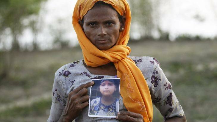 Rohiakar, a Rohingya Muslim woman, shows a picture of her daughter Saywar Nuyar, 22, who is being held by a human trafficker, at a refugee camp outside Sittwe, Myanmar.  Photo: Soe Zeya Tun 