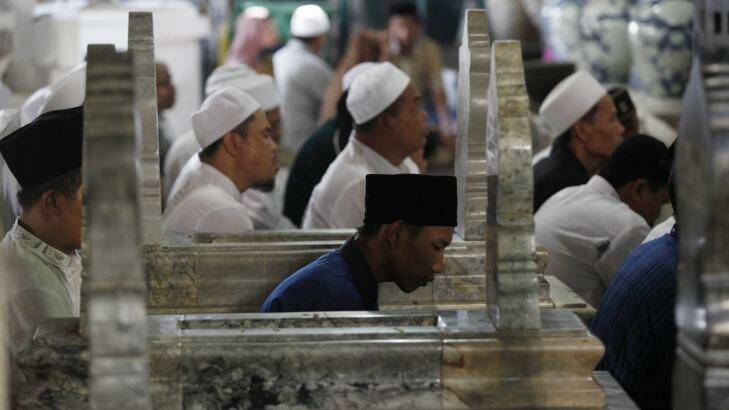 Indonesian Muslims pray between tombstones at the shrine of Sunan Gunungjati in Cirebon, West Java. Photo: Irwin Fedriansyah