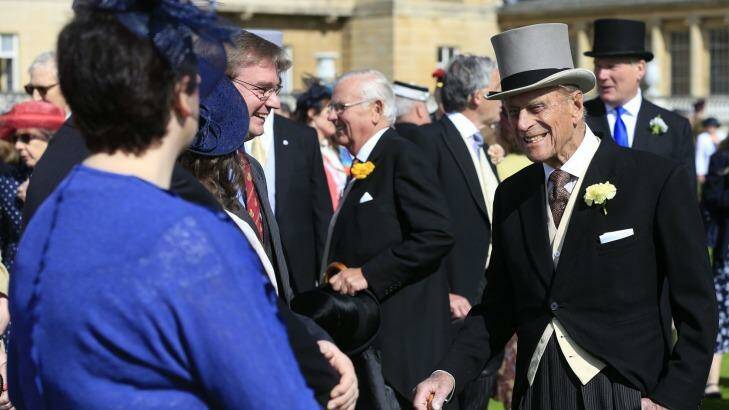 Prince Philip, right, speaks to guests during a garden party in the grounds of Buckingham Palace. Photo: JONATHAN BRADY