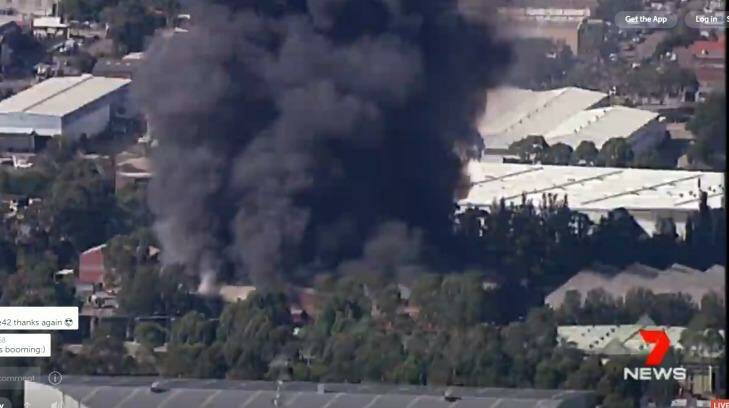 Black smoke is seen billowing from the factory fire in Chullora.  Photo: Seven News on Periscope