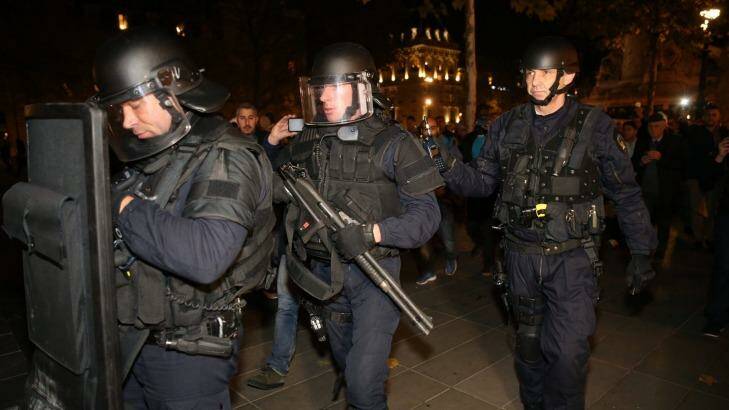Police with shotguns and a ballistics shields patrolling Place de la Republique in Paris on Sunday. Photo: Andrew Meares