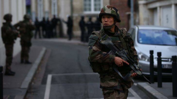 Military and police conduct an operation in St Denis in Paris. Photo: Andrew Meares