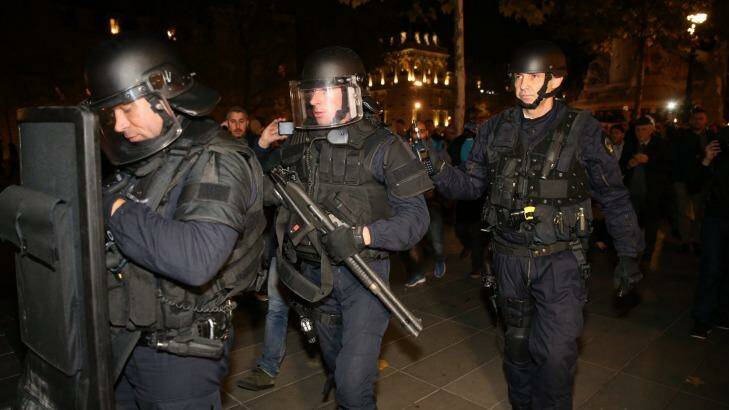 Police with shotguns and a ballistics shields patrolling Place de la Republique in Paris on Sunday. Photo: Andrew Meares