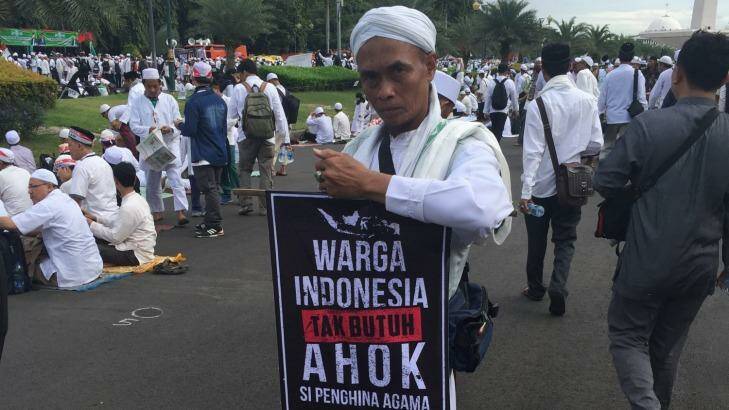 A protester carries a sign that reads "The people of Indonesia do not need Ahok" at the December rally in Jakarta. Photo: Jewel Topsfield