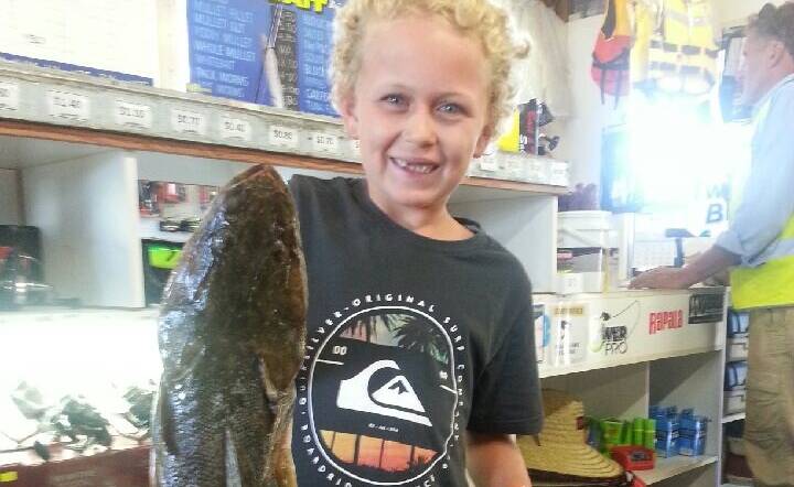 Eight-year-old Isaac Deakes with a 1.437 kg flathead he caught on a “yucky old prawn” showing that the old fashioned baits still work
