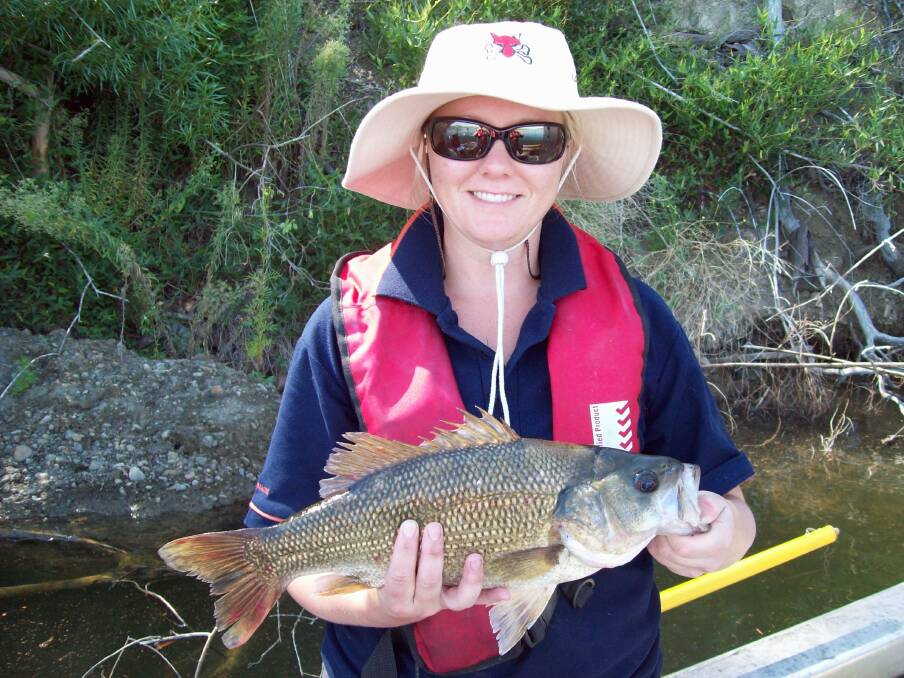 DPI Fisheries officer Prue McGuffie with an Australian Bass