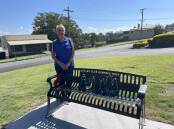 President of Rotary Club Kempsey West Judy Beilby stands proudly with the club's commemorative seat at the East Kempsey memorial site. Picture by Ellie Chamberlain