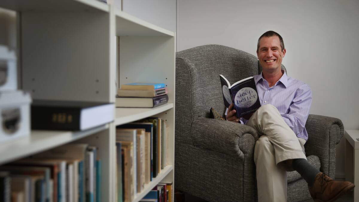 Talk about sleep: Dr Shane Pascoe of Newcastle with the new book he has co-written with sleep scientist Professor Graham Law. Picture: Marina Neil