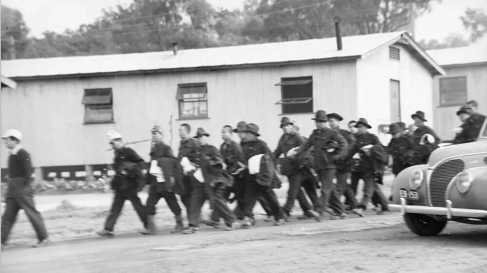 Japanese Prisoners Of War marching back to their quarters after being issued with new clothing a month before the breakout. Picture: Australian War Memorial