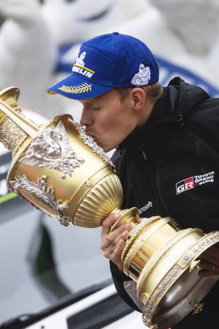 Ott Tanak kisses the Wales Rally GB winner's trophy, but a bigger prize is almost in his grasp (Jaanus Ree/Red Bull Content Pool)