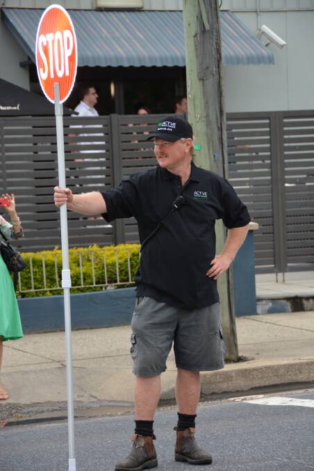 Owen Rushton gets to stop traffic on the old highway ahead of the street parade