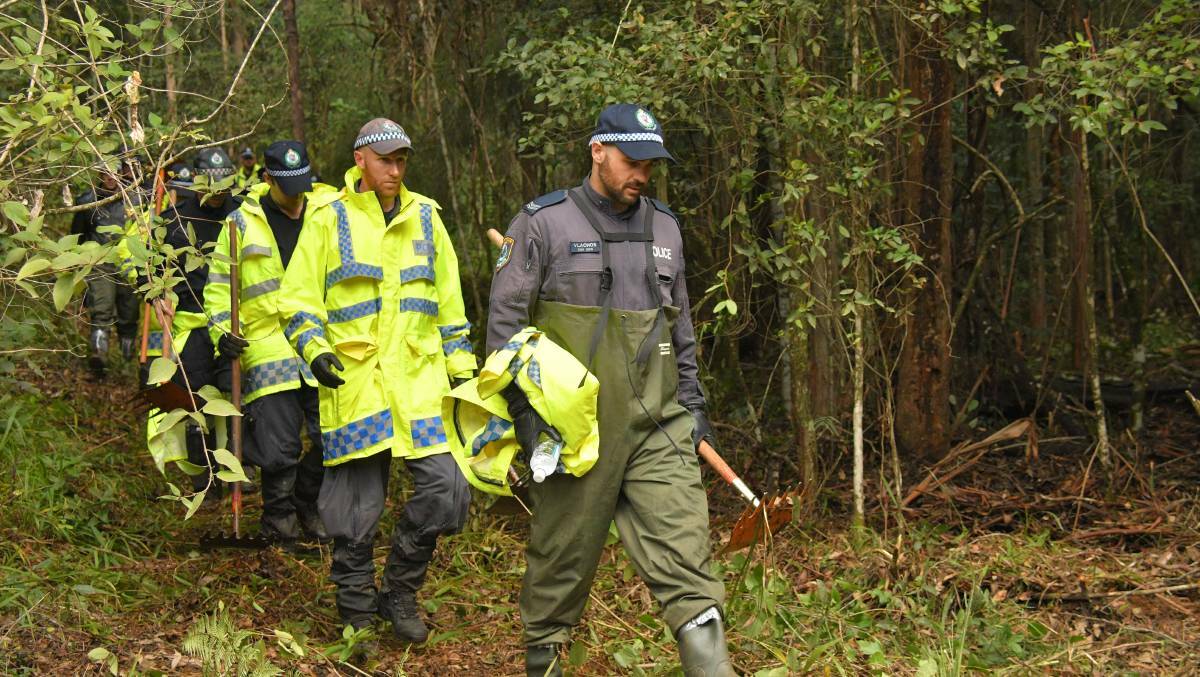 The police search in thick bushland. Photo: PortNews