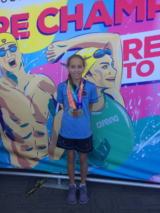 Millie Edwards at the 'photo wall' at the Games in Adelaide