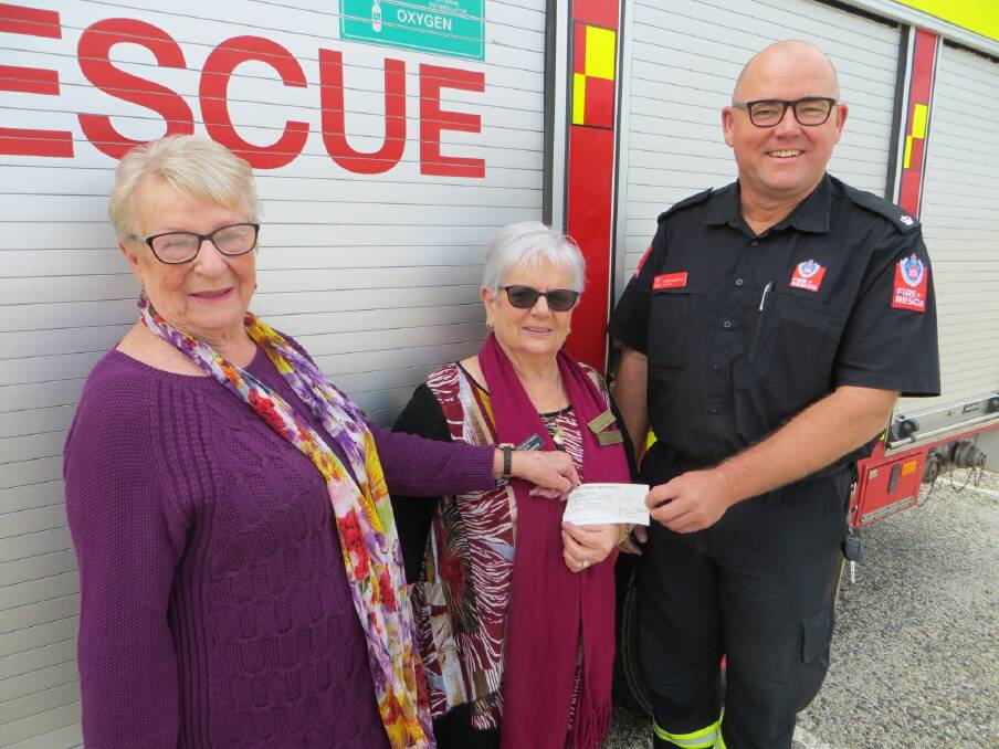 Inspector Tony Lenthall receives a cheque from Nambucca Valley Country Music Club representatives June Pettiford (left) and June Edmondson