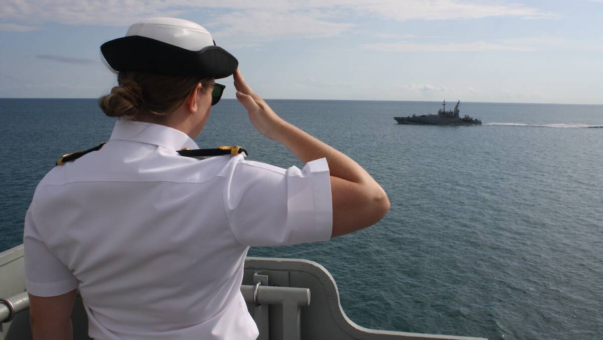 CEREMONY OBSERVED: Protocol dictates a friendly salute to a passing navy ship, in this case a patrol boat as the HMAS Darwin enters the harbour..