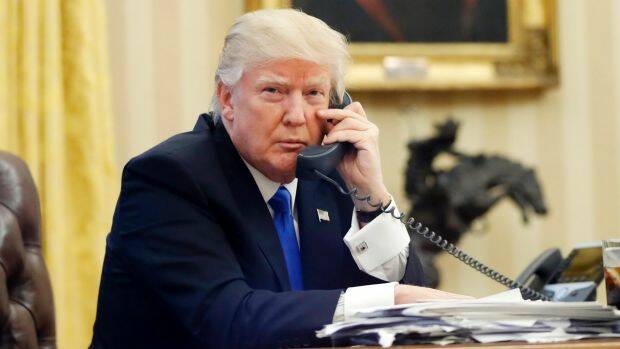 Donald Trump speaking with Malcolm Turnbull on the phone. Photo: AP
