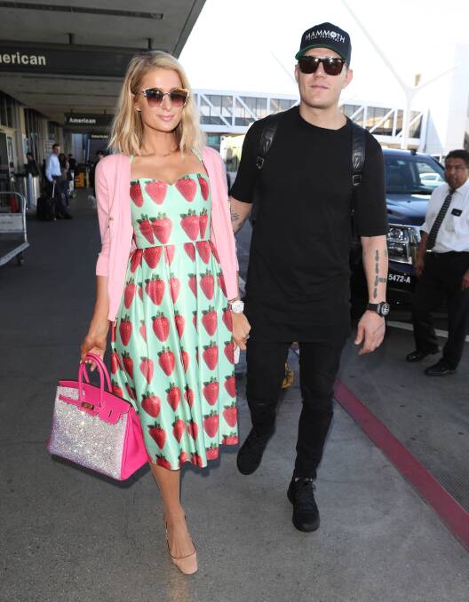 Berry nice: Paris Hilton, with fiance Chris Zylka, wears a Michelle Torres dress at LAX. Photo: AP
