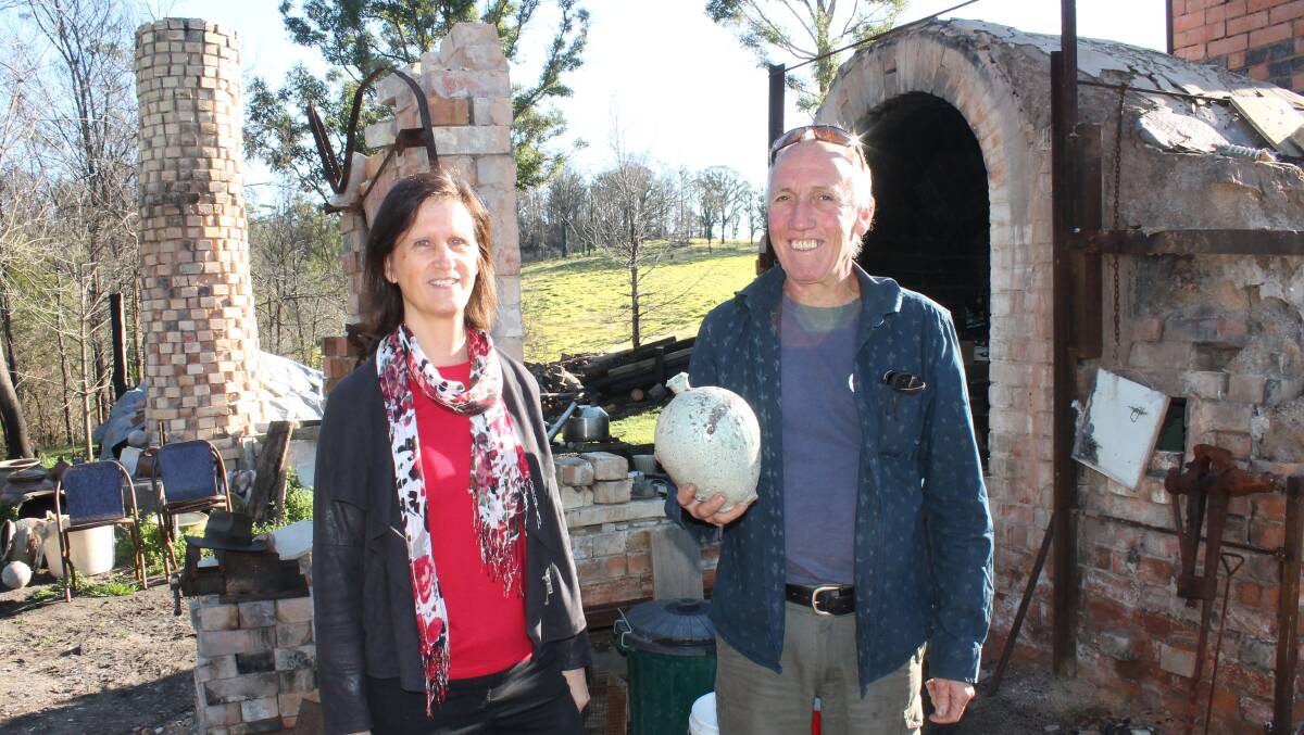 Libby Stewart visits Daniel Lafferty at the site of his studio on Thursday to collect the vase. 