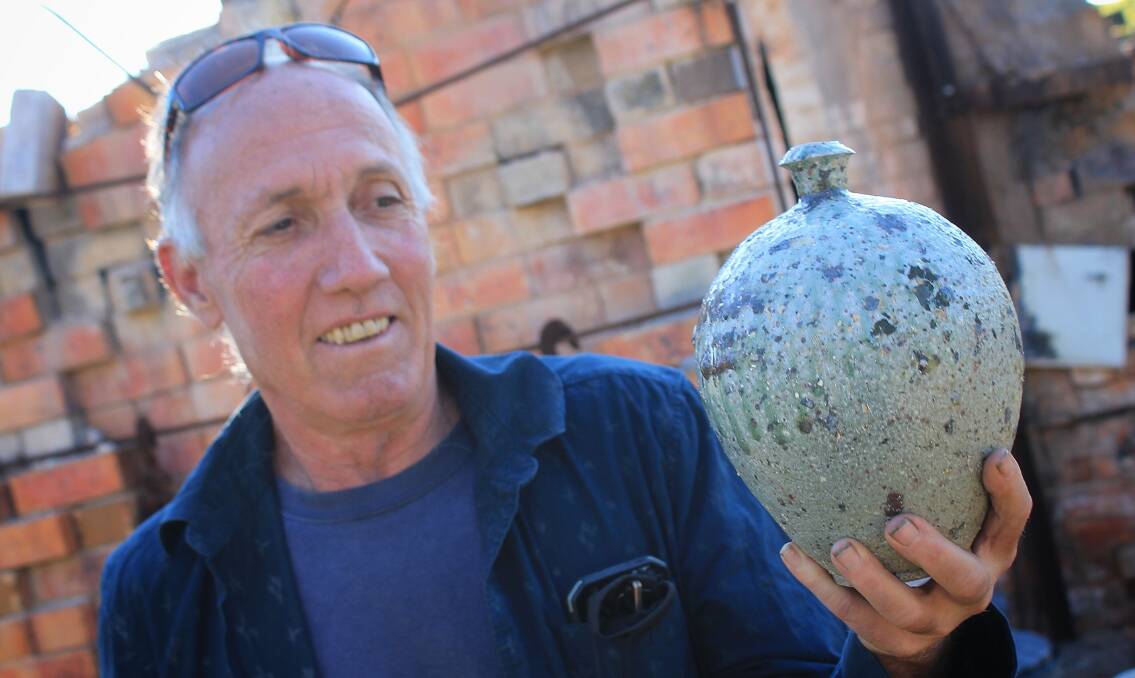 UNIQUE ART: Daniel Lafferty holds the vase that survived the New Year's Eve bushfire and will be going to the National Museum of Australia. Picture: Albert McKnight 