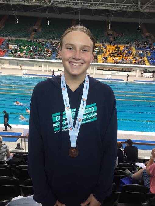 Leah Pickvance with her bronze medal for her 12 years 100m Freestyle event, a PB time of 1.02.21
