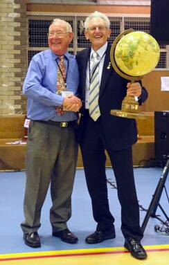 Garry Johnson accepts the Tub Nardy Trophy from past district governor Harry Durey at the Rotary District Conference at Armidale