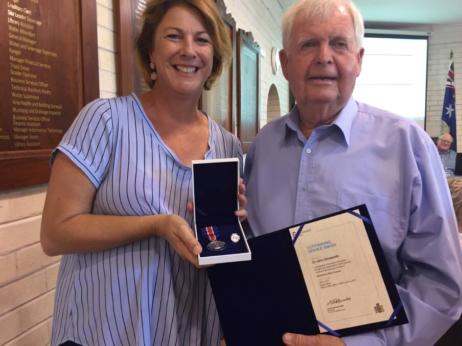 Cr John Ainsworth is awarded his 30 years' outstanding service award by Member for Oxley Melinda Pavey