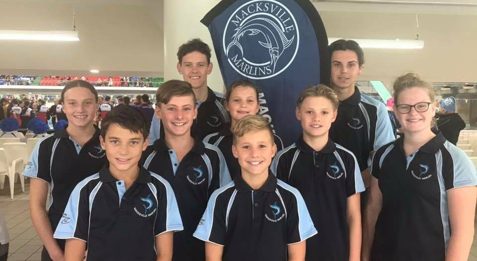 It was a proud moment for Team Marlins as nine swimmers - their largest contingent - paraded around the Sydney Olympic Park pool with their brand new club banner