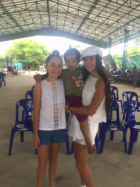 Lily and Mia with one of the orphaned children they met
