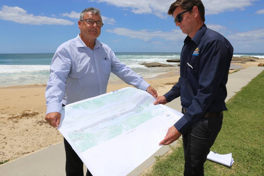 Council's Keith Williams and Grant Nelson with the plans for Stage 2 of the sea wall build