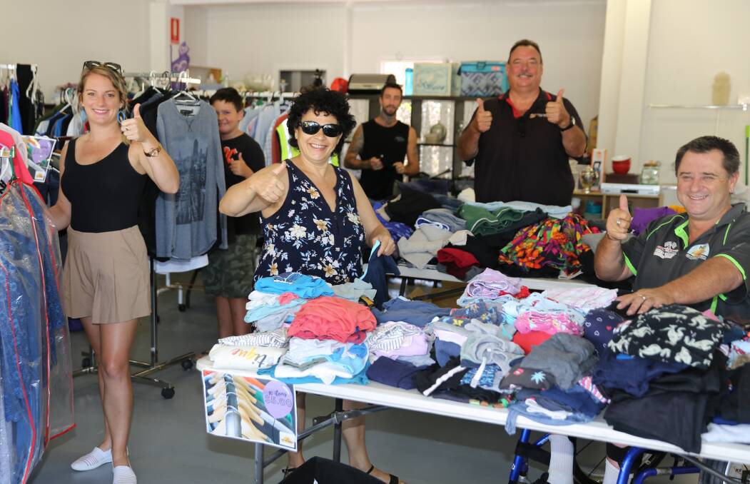 Store manager Mark Tanner (far left) and Dean Evers beside him, at their Nambucca Heads store.