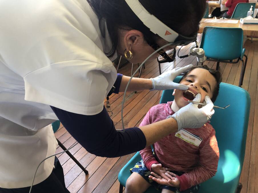 Mason having his teeth looked at by the Oral Health Team