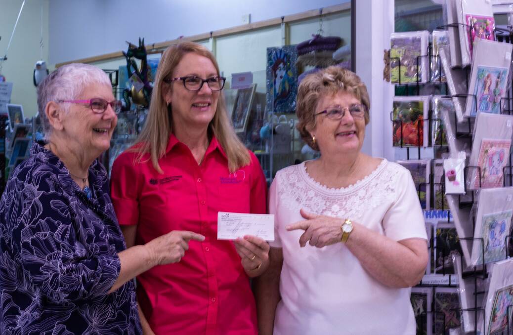 Members of the Nambucca Valley Art and Craft Group present a cheque to McGrath Foundation Breast Cancer nurse Carolyn Cross