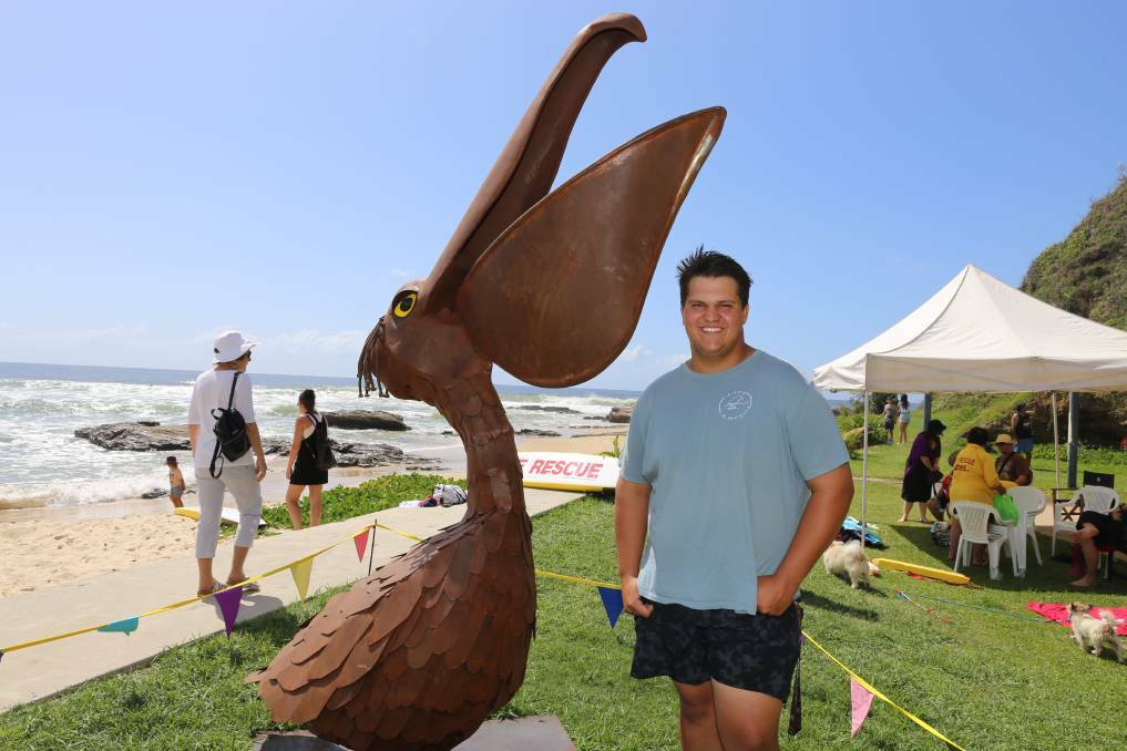 Former NHHS student Jack Edwards with the pelican statue he worked on