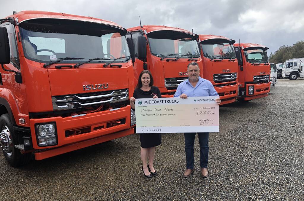 Tony Smith, Managing Director of Midcoast Trucks presenting Jane Wayland with donation of $2,500
