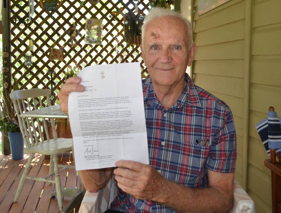 Honour: Donald Randall pictured at his Eungai Creek home with his letter notifying him of his award. Photo: Lachlan Leeming. 