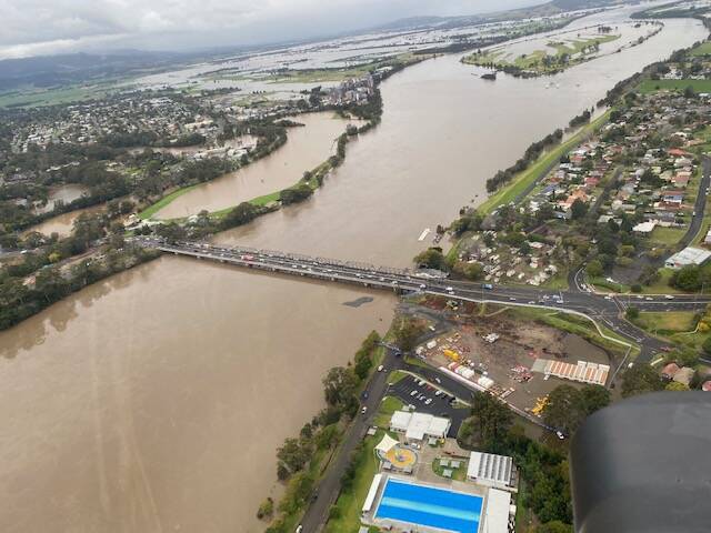 Intrepid Bolong helicopter pilot Max Cochrane and some of his Shoalhaven River flood photos.