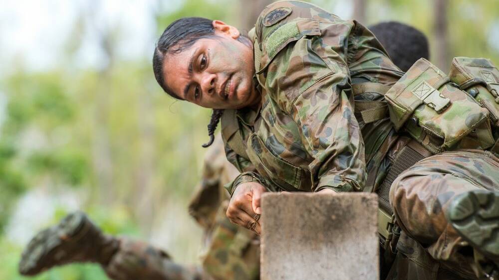 A Trainee climbs over brick wall obstacle challenge during a visit by the Army Indigenous Development Programme to Robertson Barracks in November 2017. Photo supplied by Department of Defence