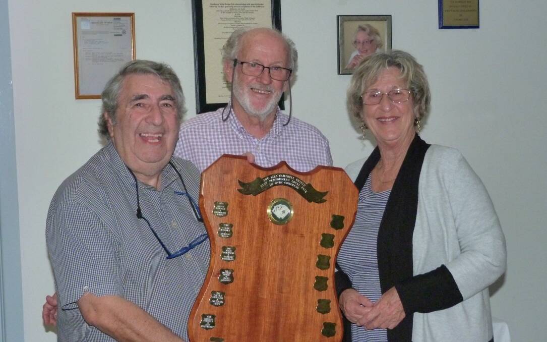 BRIDGE: Club president John Slade (centre) presenting the Isla Campbell Memorial Trophy to Richard Levy and Cynthia Gill for being the best local pair. Photo: supplied.