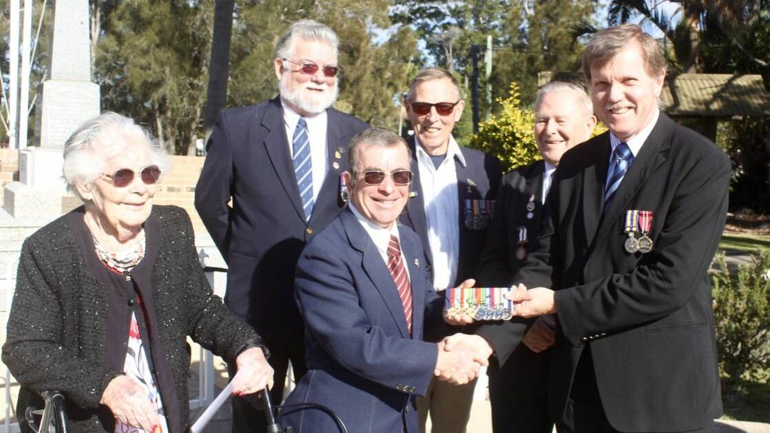 Tommy Reynolds is presented a replica set of his grandfathers Medals by President of the NBH RSL Sub Branch Mr David Stephenson. Also pictured is Tommy's Mother, Barbara and his mates John Kent, Dennis Lane and Michael Targett. Photo by Mick Birtles.