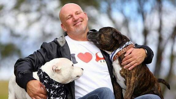 With two of his beloved dogs, Bisho, also known as Glenn Bishop is recovering after breaking up a nasty dog fight. 