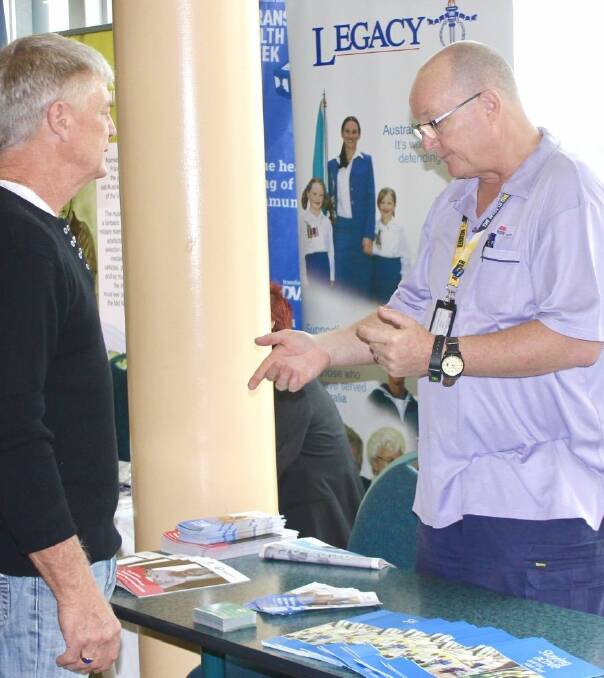 Cynthia and John Guyenette of Nambucca Heads visit the Mens Health Peer Education Stand where they are assisted by Spot Swalles, Wally Sweet and Bob Crisp.
