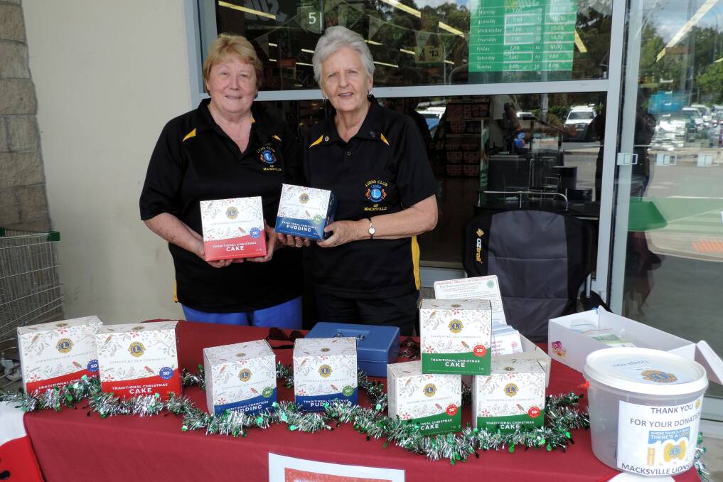 Lions Heather Battle and Margaret Patmore of Macksville Lions showing off the range of cakes and puddings available. Photo supplied.